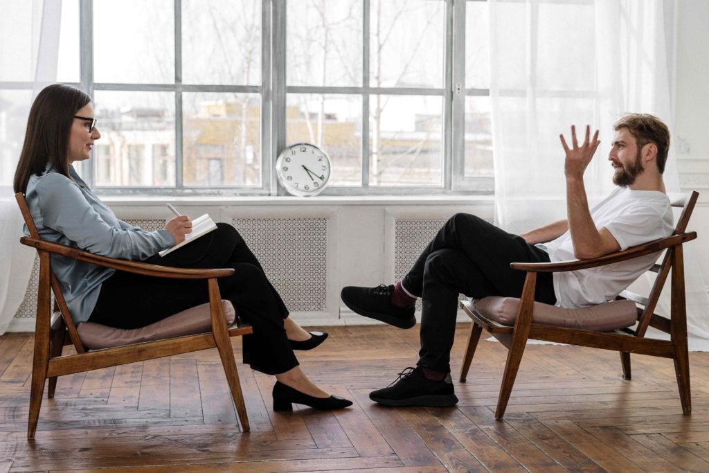 Man and Woman sitting in a life coaching session