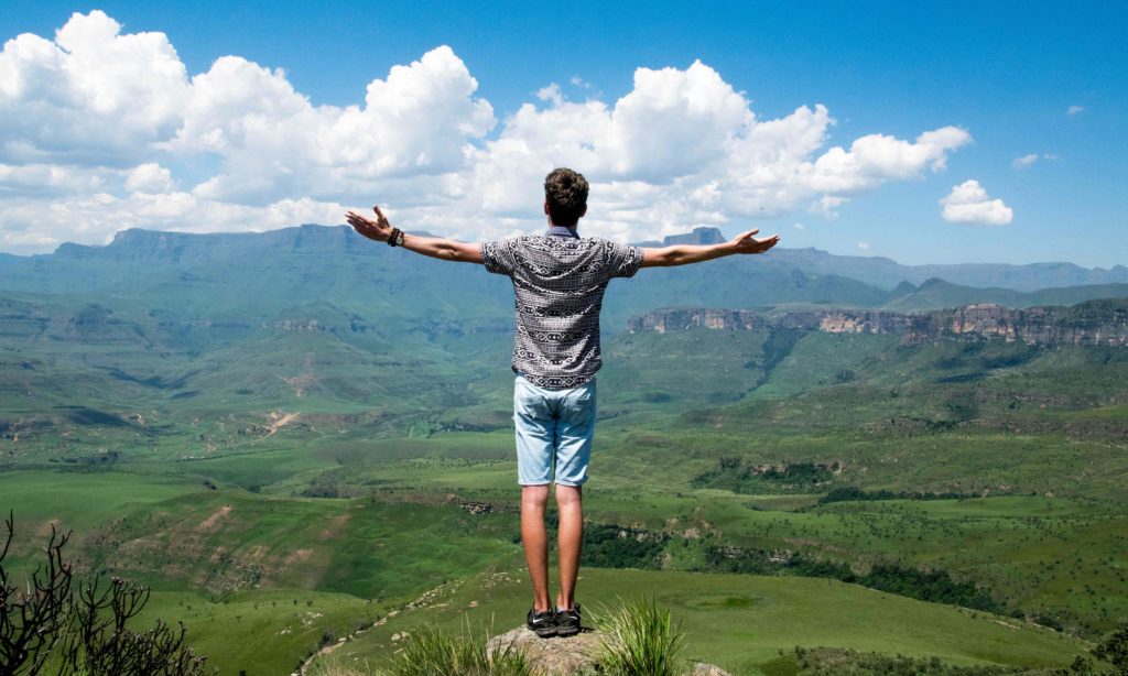 man standing with arms open