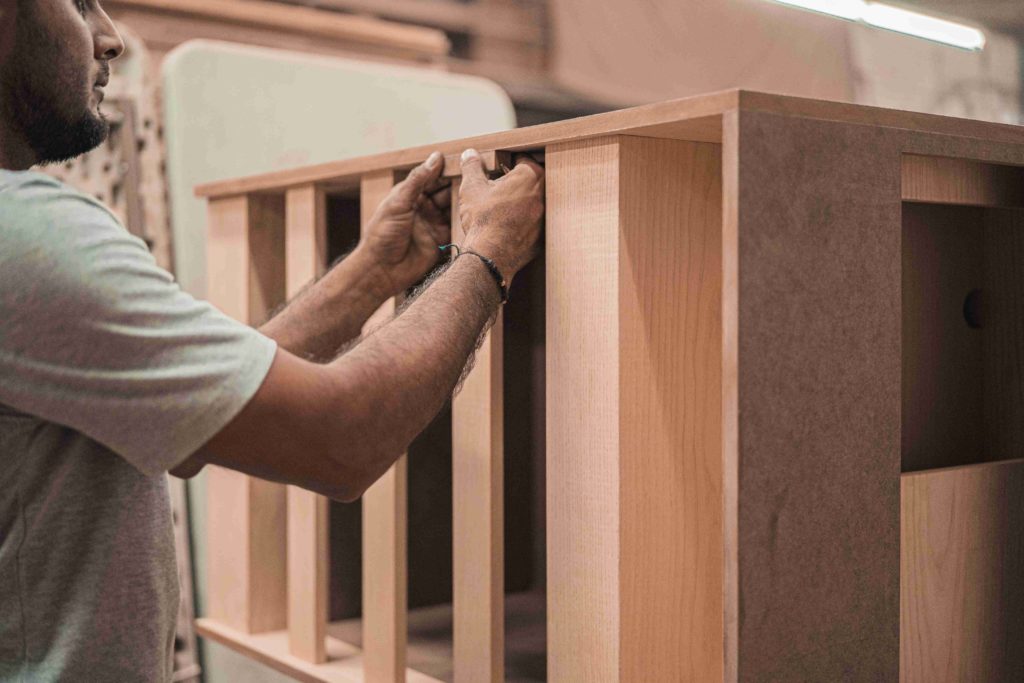 carpenter setting wooden railing